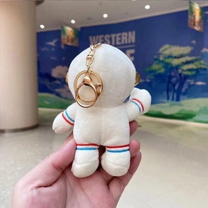 Cute astronaut bunny plush keychain with red and blue stripes and a golden metal ring