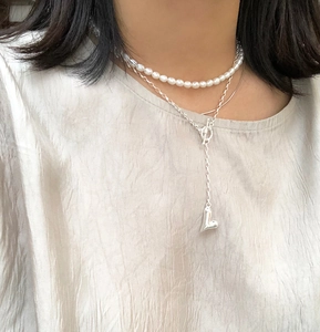 Detailed view of layered 925 silver necklace with heart pendant and freshwater pearls