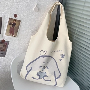 Detail of cream canvas tote bag with hand-drawn dog illustration on a white chair