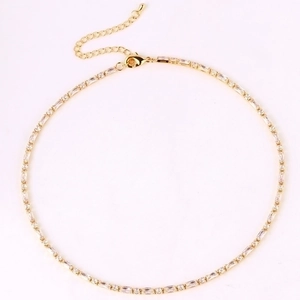Detailed top view of gold tennis necklace with emerald cut cubic zirconia and extension chain