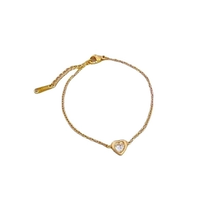 Titanium steel heart bracelet with clear cubic zirconia stone on a gold polished chain