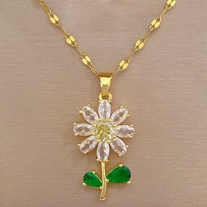 Macro shot of titanium steel flower necklace with green leaves and micro-inset crystals