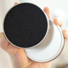 Macro view of portable makeup brush cleaner tin with black porous sponge liner interior