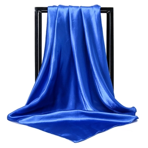 Close-up of royal blue satin square scarf showing silky texture and smooth rolled edges