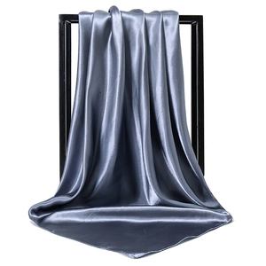 Elegant silver grey satin silk square scarf for women displayed on a modern black frame