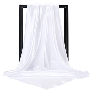 Detail shot of elegant white satin square scarf showing glossy texture and soft drape