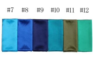 Detail showing smooth satin fabric samples in various shades of blue and green squares