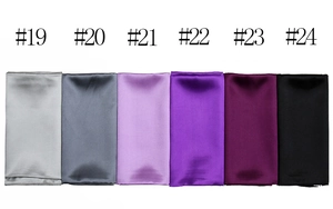 Detail showing smooth satin silk square scarves in six colors including grey and burgundy