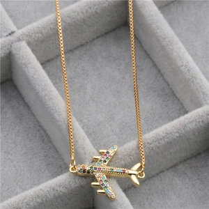Gold-plated airplane pendant necklace with colorful micro-inlaid zircons on a gray velvet box