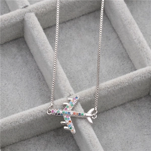 Silver airplane necklace with colorful zircon stones in a velvet jewelry box
