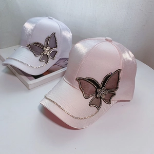 Elegant satin baseball cap with rhinestone butterfly and chain trim in white and pink