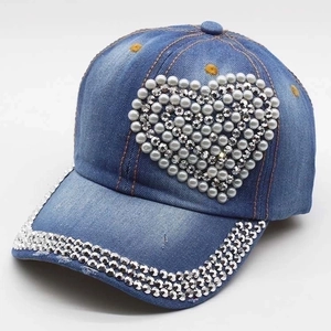 Women's denim baseball cap with rhinestone heart and pearl details on blue fabric