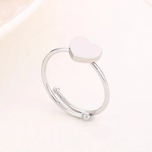 Macro shot of silver adjustable open heart ring with dual metal beads on polished band
