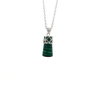 Detailed macro view of green malachite cylinder pendant with silver hollow pattern and chain
