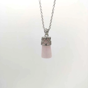 Close-up of rose quartz pendulum pendant with intricate silver cutout pattern