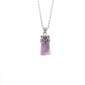 Detailed view of purple crystal pillar pendant with silver heart hollow metal setting