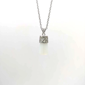Close-up of a silver sword-shaped natural stone pendant with hollow heart metal cap