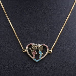 Detail of gold heart pendant necklace featuring micro-set colorful zircon kissing couple