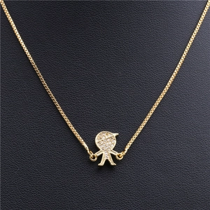 Detailed view of a gold-tone boy pendant with micro-pave zircons on a box chain