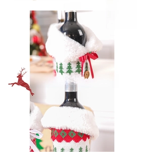 Detail of Christmas knitted wine bottle covers with red and green Nordic patterns