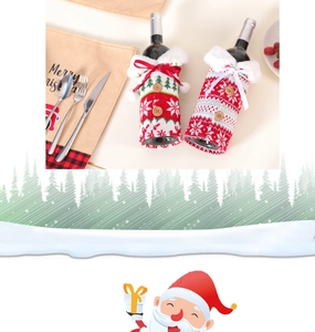 Detail of knitted Christmas wine bottle covers with reindeer, snowflakes and festive bows