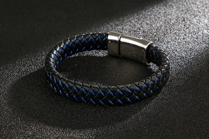 Macro shot of black and blue braided leather bracelet with stainless steel magnetic clasp