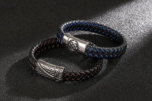 Detailed close-up of woven leather bracelets with silver skull clasps in blue and bronze
