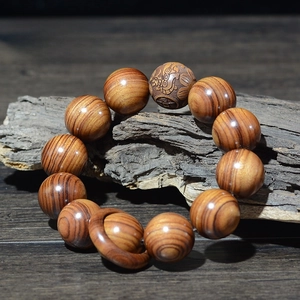 Détail de perles en bois de Huanghuali 20mm avec anneau décoratif et sculptures