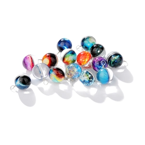Close-up of assorted galaxy glass pendants with colorful nebulae and metal loops