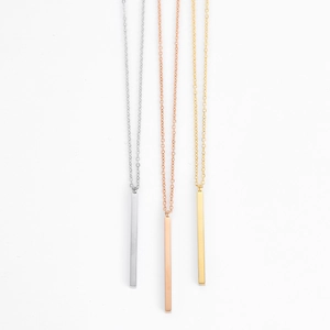 Three minimalist stainless steel bar pendant necklaces in silver, gold, and rose gold finishes