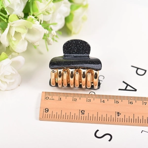 Sparkly black and gold 4cm acrylic hair claw clip with star dust finish