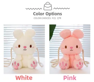 Detail view of rabbit plush crossbody bags in white and pink with woven straps