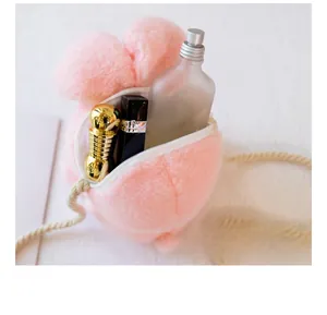 Pink plush rabbit crossbody bag showing interior storage for lipstick and perfume