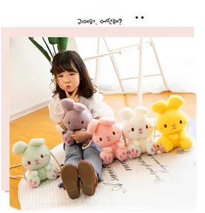 Close-up of colorful plush bunny shoulder bags for kids with soft braided rope straps