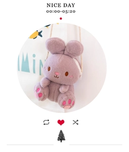 Detail of purple plush bunny bag with pink embroidery and white shoulder strap