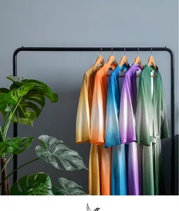 Detail view of colorful gradient waffle weave bathrobes hanging on a clothing rack