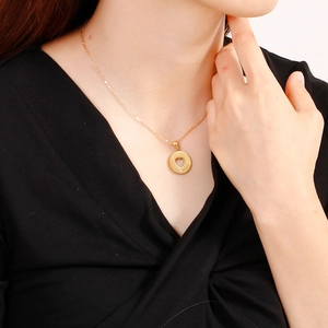 Elegant gold titanium steel necklace featuring a hollow heart round pendant with zircon