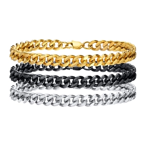 Close-up of three Cuban link bracelets in gold, black, and silver stainless steel