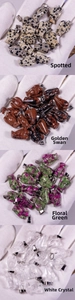 Detailed close-up of hand-carved stone angel pendants in quartz and crystal materials