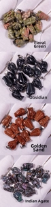 Detailed view of angel stone pendants in obsidian, green stone, and agate with metal clasps