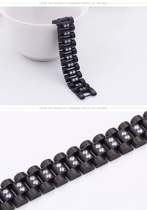 Macro shot of black stainless steel bracelet with crystal-inlaid metal link texture