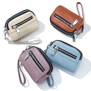 Mini leather coin purses in beige, brown, purple, and blue with lychee texture