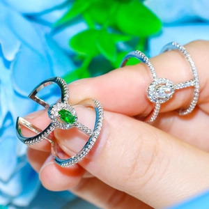 Elegant adjustable silver ring set with marquise green stone and clear cubic zirconia gems