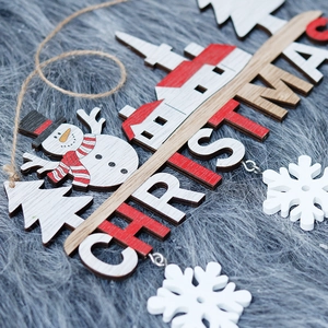 Creative wooden Christmas hanging ornament with snowman and house on grey plush surface