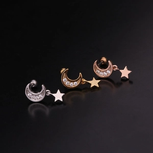 Detail of moon and star drop screw back earrings in silver, gold, and rose gold finishes