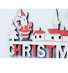 Macro detail of wooden Christmas door sign with reindeer and festive letter engraving