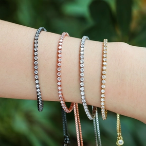 Stack of four colorful zircon tennis bracelets in gold, silver, rose gold, and black finishes