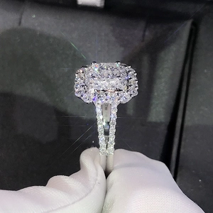 Macro view of cushion cut halo ring with double pave diamonds on split shank
