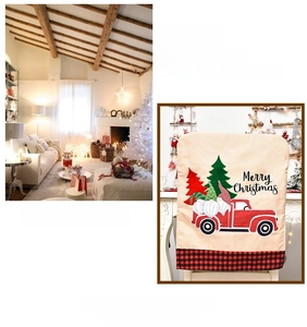 Detail of Christmas chair cover featuring Santa Claus, red truck and Merry Christmas text