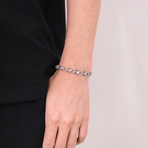 Silver stainless steel chain bracelet with interlocking circular links on male wrist